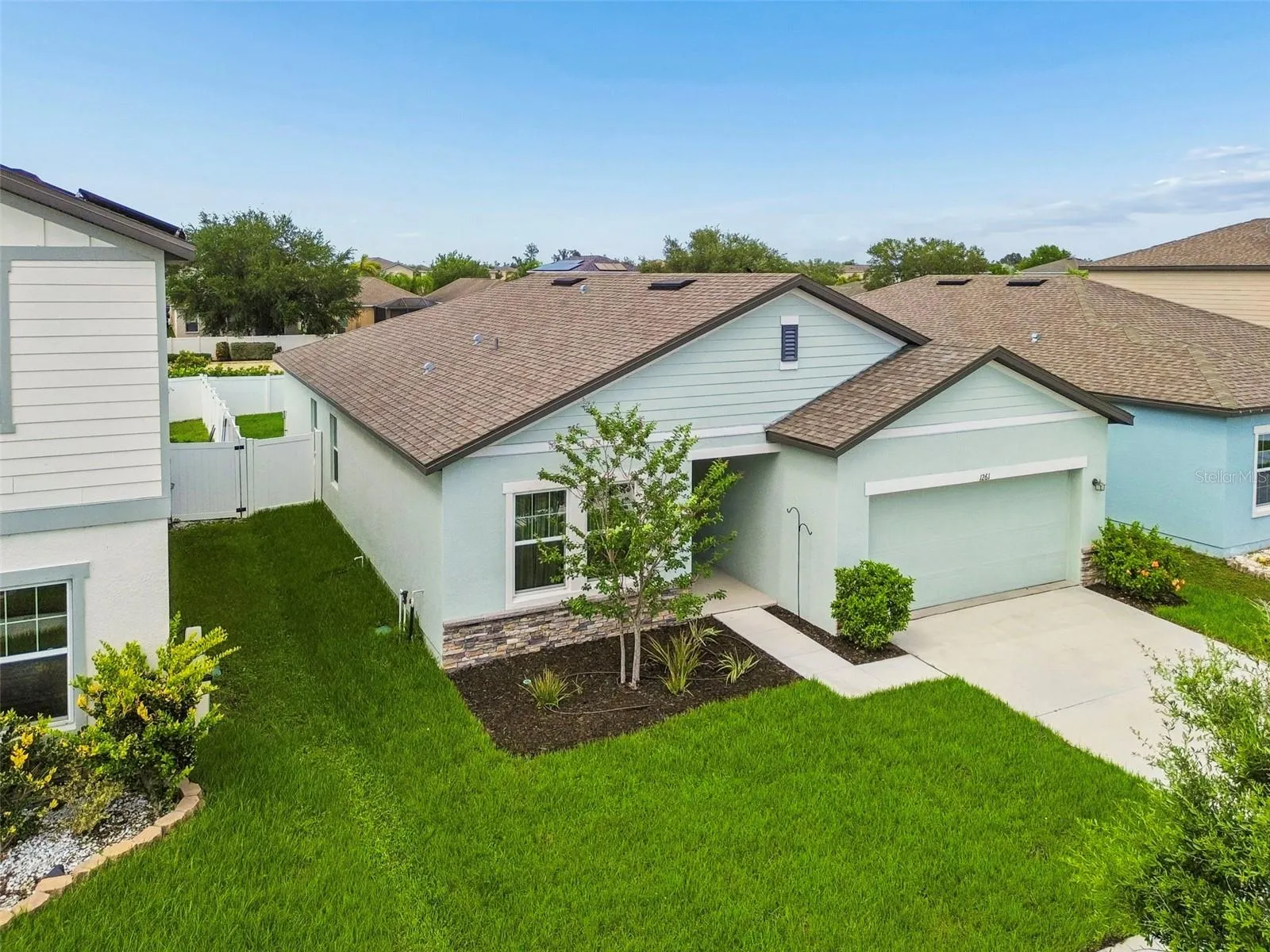 Beautiful modern curb appeal! Featuring contrasting dark trim, stone accents, and meticulously maintained lawn!