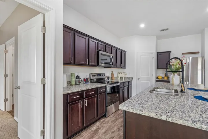 Hugh Kitchen features Oversized Island upgraded faucet and walk in pantry
