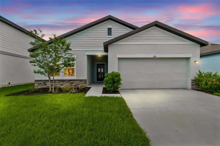 Beautiful modern curb appeal with clean architectural lines. Featuring contrasting dark trim, elegant stone accents, ample covered entrance and new manicured landscaping and lush lawn!