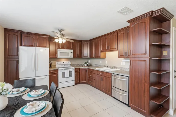 Kitchen with WHT Appliances and Cherry Wood Cabinets