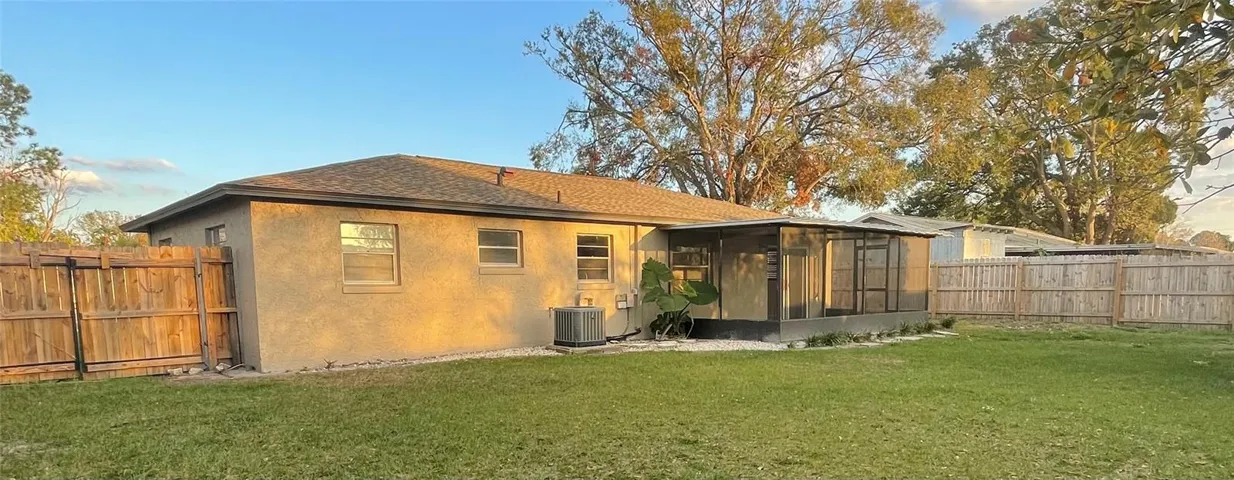 Back yard with fence & screened patio