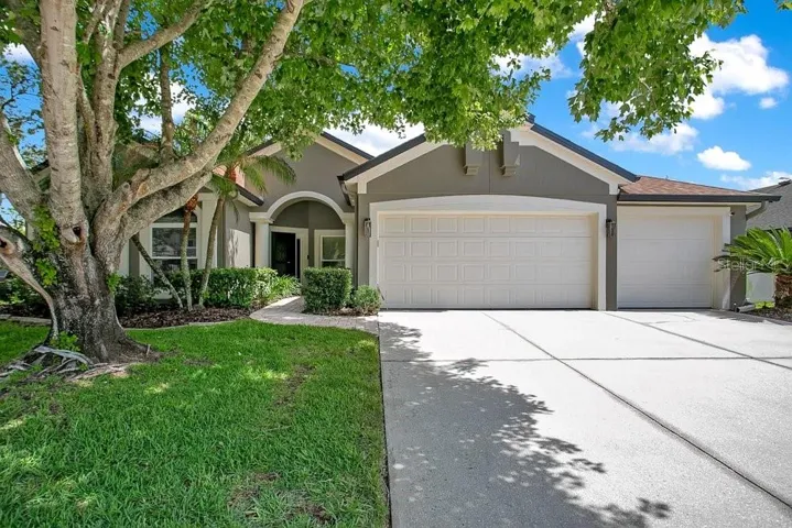 Welcome home to this beautifully maintained property with mature landscaping and charming arched windows.