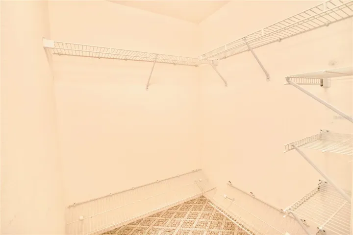 One of Two Walk-In Closets in Primary Bedroom