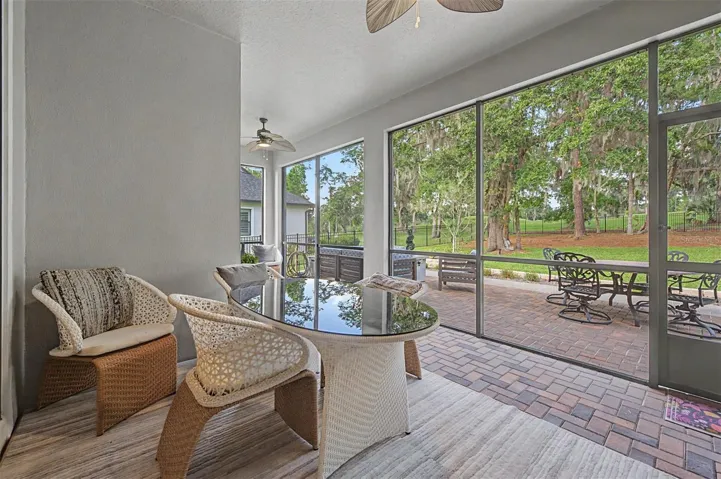 Screened back lanai overlooking backyard & golf course