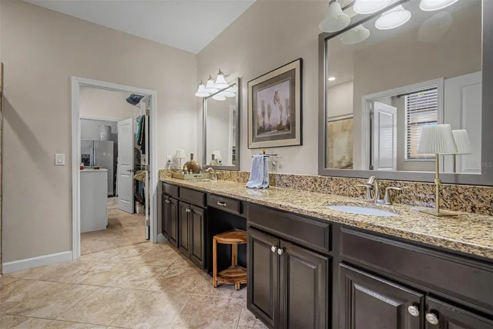 Primary bathroom with dual sinks, vanity area and large shower