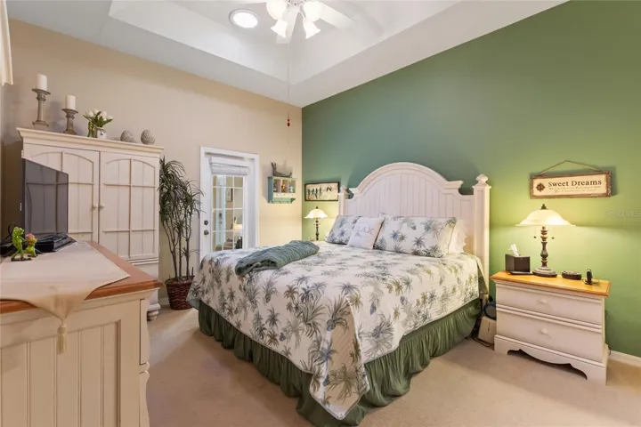En suite primary bedroom with solar tube & french door access to FL Room
