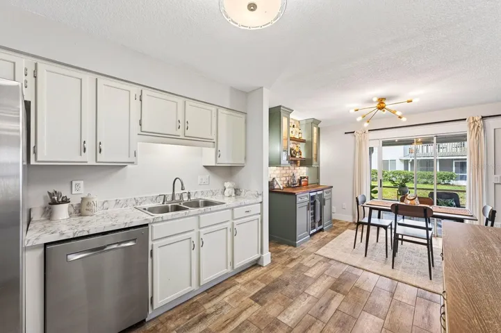 At the heart of the home, the stunning UPDATED Kitchen truly shines with crisp white cabinetry, marble-look countertops, stainless steel appliances, and a WALK-IN PANTRY CLOSET.