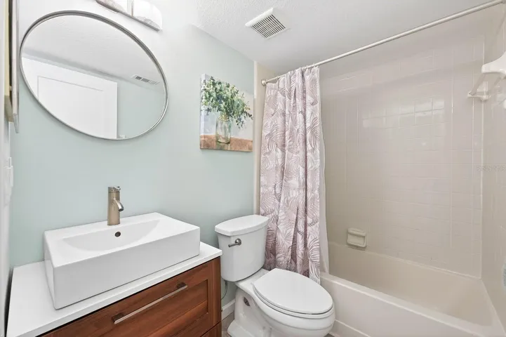A second spacious bedroom and nearby full bath provide flexibility for guests, family, or a home office.
