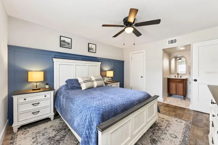 The GENEROUS PRIMARY SUITE offers a relaxing private retreat, complete with a walk-in closet and beautifully UPDATED EN SUITE BATH featuring a modern vanity and sleek step-in shower.