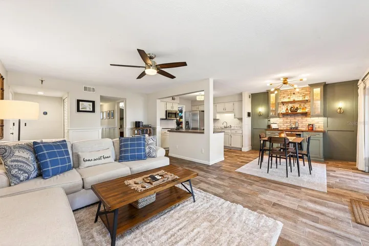 Step inside and immediately appreciate the bright open-concept layout, where the Living Room, Dining area, and Kitchen flow seamlessly together beneath an abundance of NATURAL LIGHT.