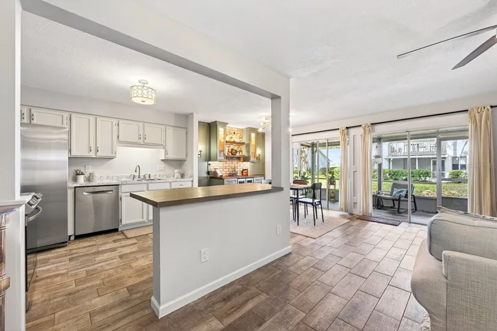 A center island with breakfast bar seating provides extra prep space and a comfortable spot for quick meals.