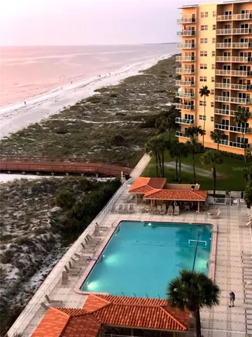 Spectacular aerial view of the resort-style pool set against the pristine Gulf coastline.