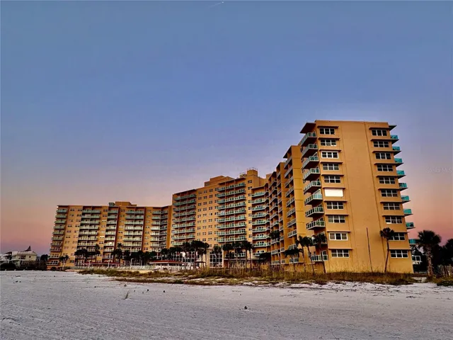 Golden hour highlights the striking architecture of this premier beachfront community.