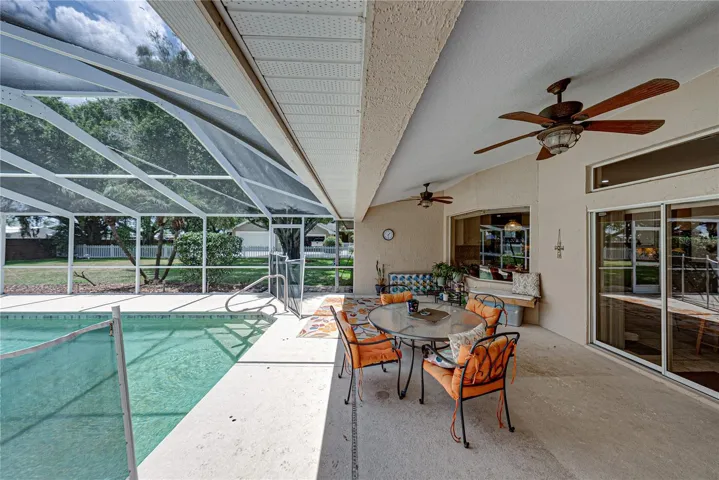 The large birdcage encloses the entire pool area.