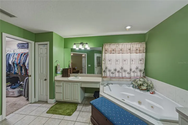 The primary suite large walk-in closet is located in the primary bath.