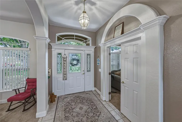 The foyer gets great natural light from the leaded glass front door and sidelights with over the transom window.