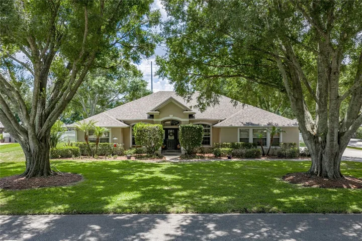 Stately oak trees grace the front yard.