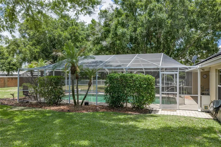 The large birdcage covers the entire pool area.