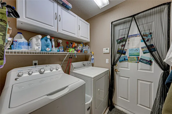 The inside laundry room doubles as a mud room for the attached 2 car garage. The washer and dryer stay.