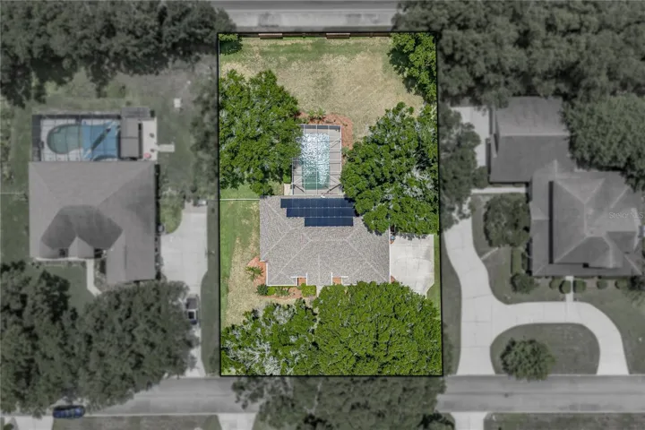 Stately oaks are in the front and back yards.