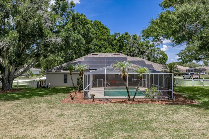 The backyard is enclosed by a vinyl fence.