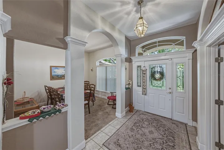 The dining room is defined by the arches and pass through half walls.