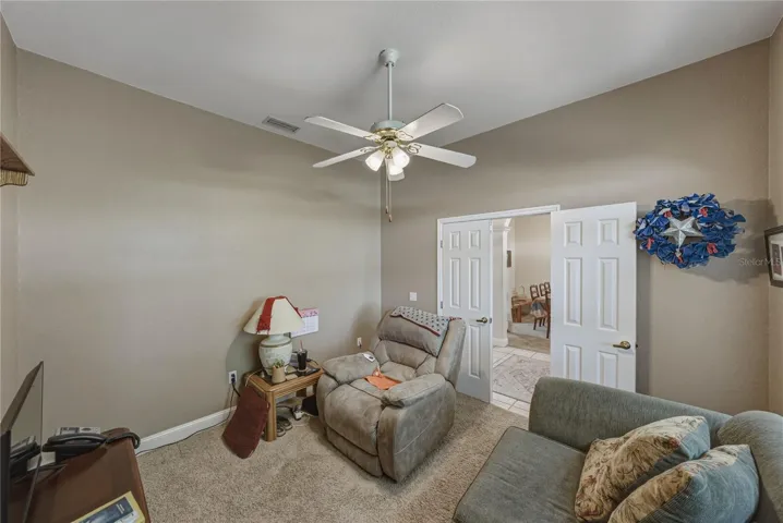The den has a double door when privacy is desired.