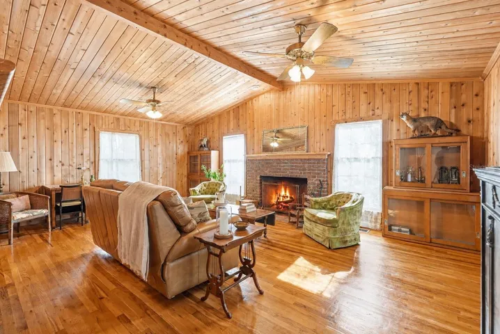 Featuring soaring tongue-and-groove wood ceilings, natural wood walls all anchored by a classic wood burning brick fireplace.