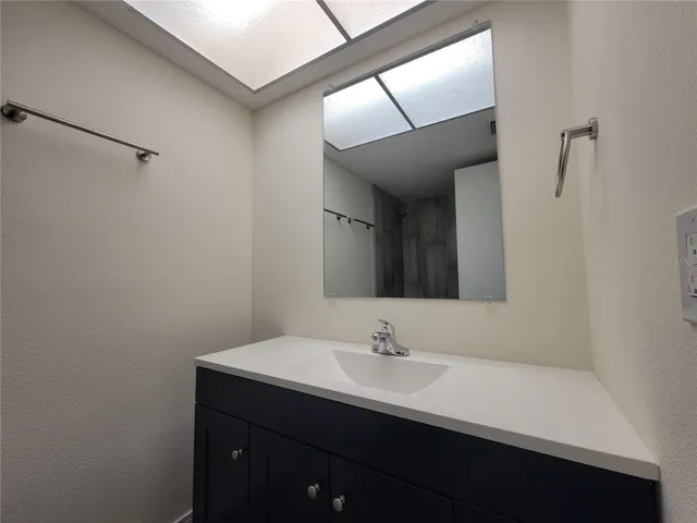 Renovated en-suite bathroom with new vanity, fixtures & hardware.