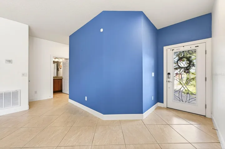 From the moment you arrive, the home impresses with its BRICK PAVER DRIVEWAY AND WALKWAY leading to a stunning ETCHED GLASS FRONT DOOR, creating beautiful curb appeal and a warm welcome.