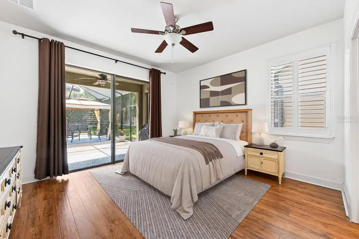 All bedrooms feature ATTRACTIVE LAMINATE FLOORING, including the GENEROUS PRIMARY SUITE, where sliding glass doors fill the room with natural light and provide direct access to the lanai. Virtually Staged