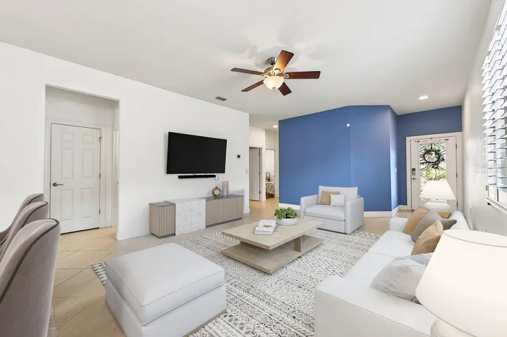 Inside, the home features PORCELAIN TILE FLOORING throughout the main living areas, while windows with PLANTATION SHUTTERS fill the space with NATURAL LIGHT and timeless elegance. Virtually Staged