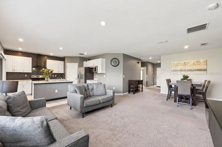 Conveniently adjacent to the Kitchen and Dining area, the Living Room invites connection and comfort.