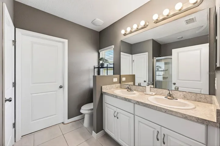 The Primary Bedroom features a GENEROUS WALK-IN CLOSET and an EN SUITE BATH with dual sinks and a step-in shower, creating a peaceful retreat at the end of the day.