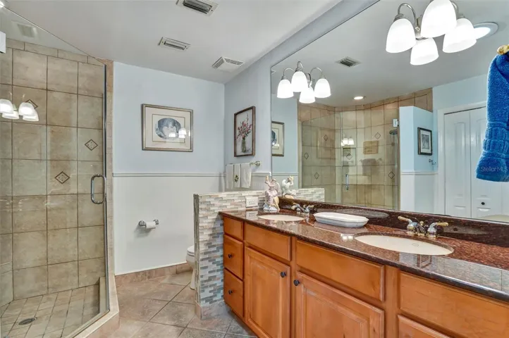 Primary bathroom suite - renovated with two lavatories and spacious shower.