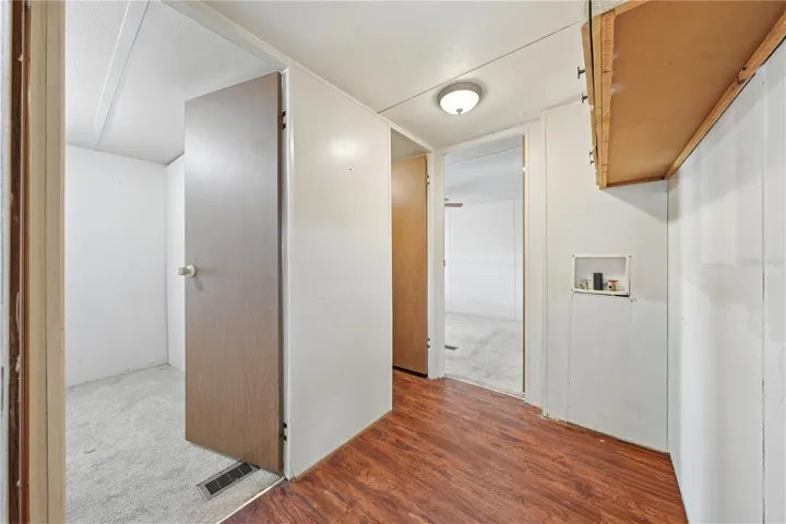 Laundry connections in hallway across from bathroom
