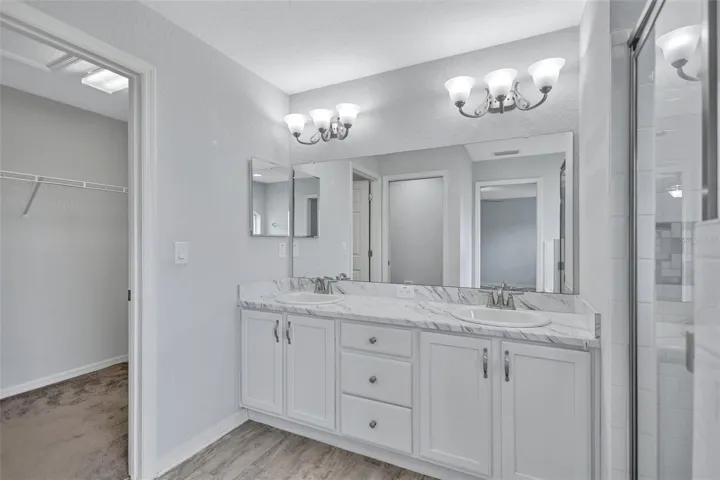 Primary EnSuite featuring Dual Sinks and Walk-In Closet