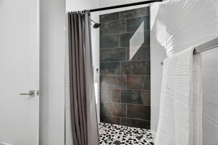 Gorgeous tiled shower on main level.