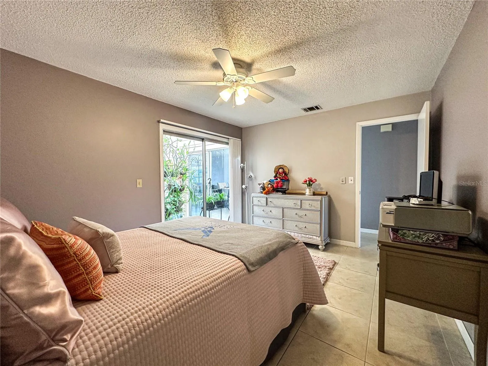 2nd bedroom shares access to interior green garden.