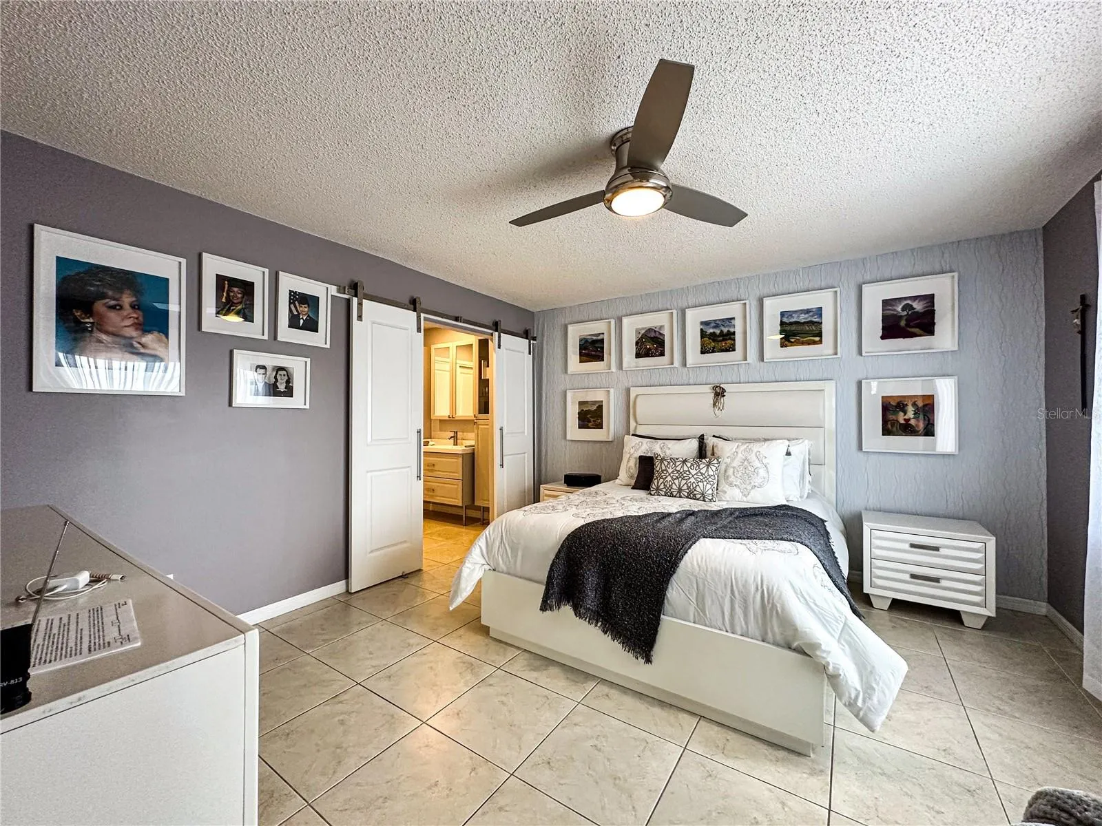 Another view of the Primary Bedroom with the entrance double barn door to the In suite bathroom