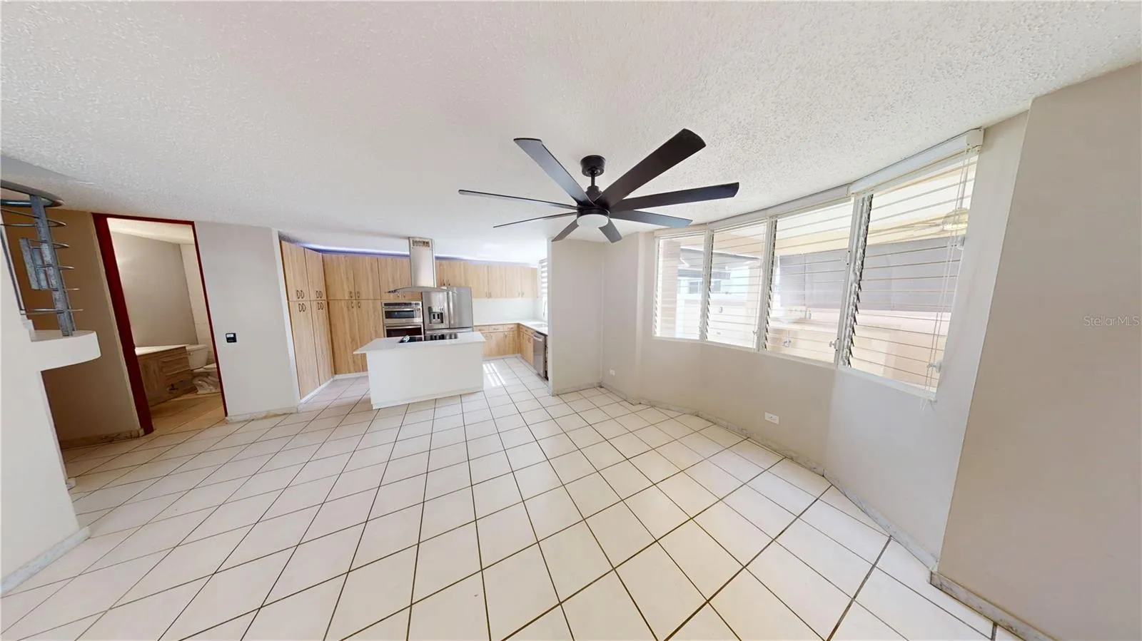 A conveniently located family room connects the kitchen with the terrace access, creating an easy flow for everyday living and entertaining