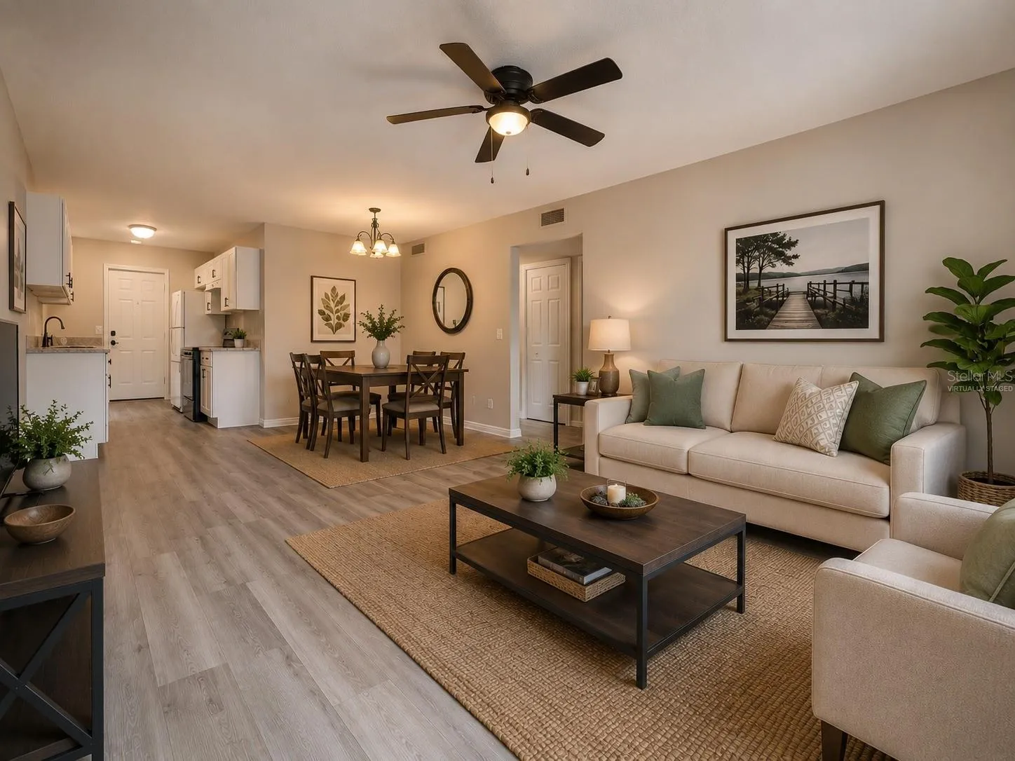 Virtually staged living, dining, and kitchen area, viewed fromentrance