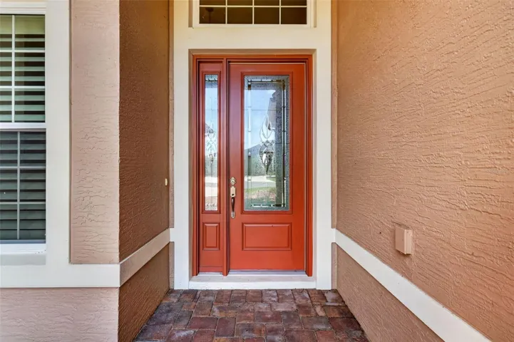 LOVELY ENTRANCE WITH LEADED GLASS FRONT DOOR AND SIDELITE.