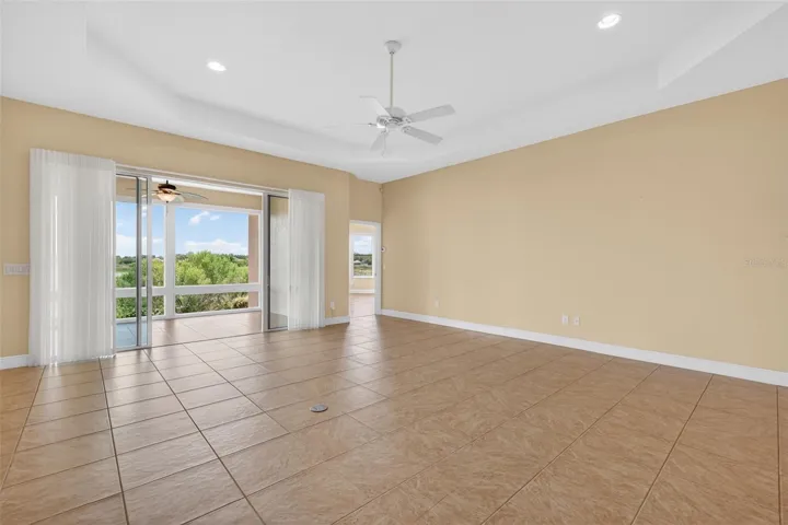SLIDING GLASS DOORS WITH LUMINETTE VERTICAL SHEER BLINDS OPEN TO THE GLASS ENCLOSED LANAI AND SPECTACULAR VIEW!