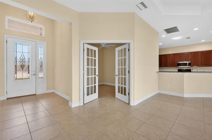 FRENCH DOORS OPEN TO THE DEN/OFFICE OR EVEN A 4TH BEDROOM IF NEEDED.