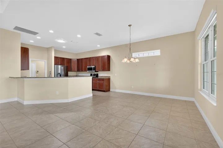 DINING ROOM ON THE RIGHT WITH VIEW OF THE LAKE AND CONVENIENT TO THE KITCHEN.