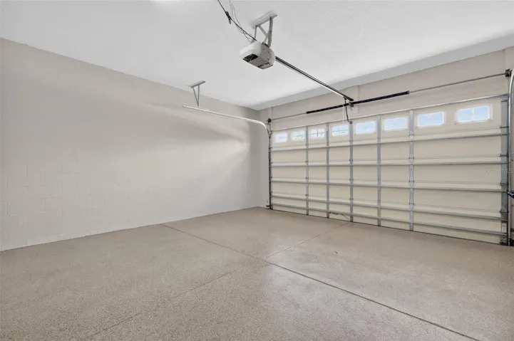 2 CAR GARAGE WITH PAINTED FLOOR AND INSULATED DOOR.