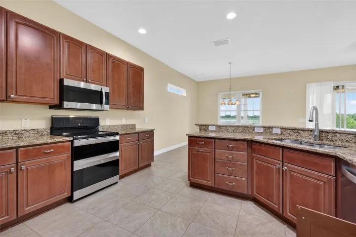 STAINLESS APPLIANCES WITH SMOOTH TOP ELECTRIC STOVE AND DOUBLE OVEN.
