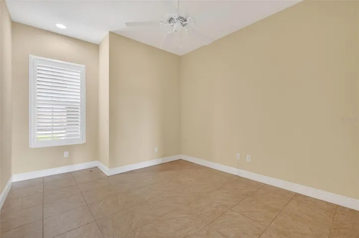 PLANTATION SHUTTERS AND CEILING FAN IN DEN/OFFICE.