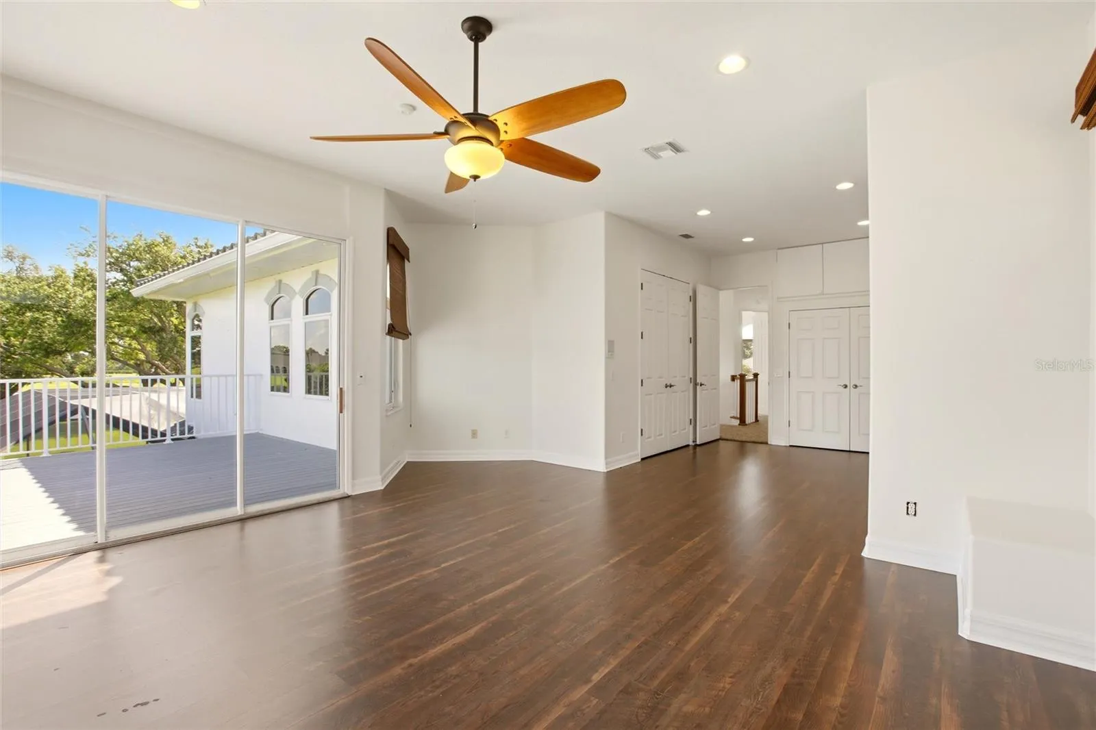 The spacious bonus room offers exceptional versatility, serving as an ideal playroom, guest quarters, media room, or workout space. It is well-appointed with a wet bar, refrigerator, washer and dryer, and a large storage closet, and opens through sliding glass doors to a private second-floor balcony overlooking the lake and golf course. A dumbwaiter provides convenient access from the kitchen below.